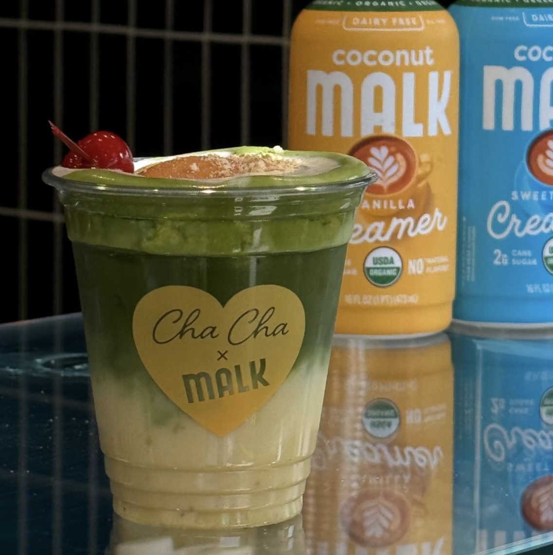 MALK coconut creamers featured behind banana cream iced matcha latte at Cha Cha Matcha pop-up
