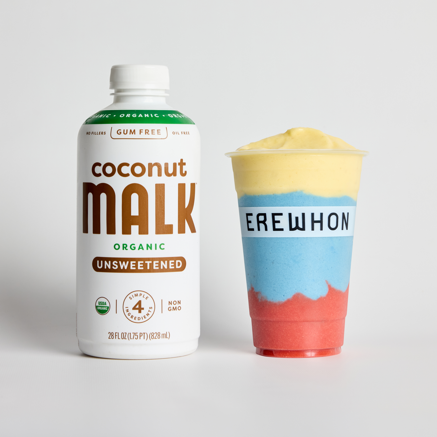 Bottle of MALK Organic Unsweetened Coconut Milk next to Erewhon’s colorful Chimba de Smoothie by J Balvin.