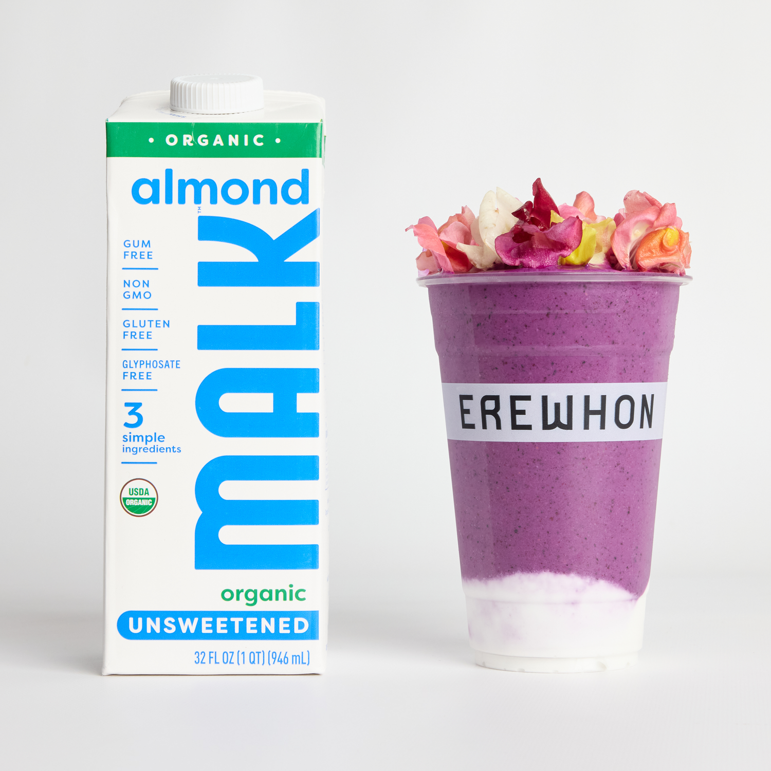 MALK Organic Unsweetened Almond Milk next to Erewhon’s purple “You’re Doing Amazing” smoothie by Kris Jenner topped with edible flowers.
