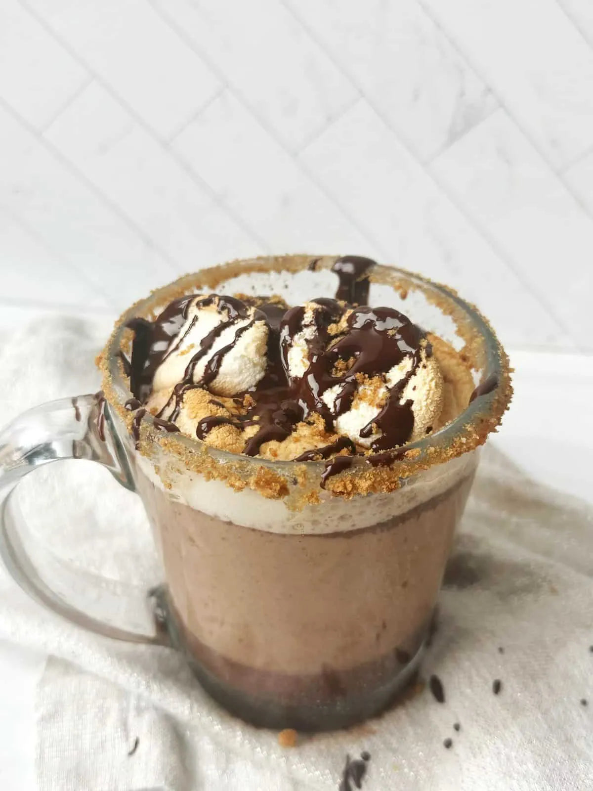 Dairy-free hot chocolate using MALK Organics Unsweetened Almond Milk with vegan marshmallows and seasonal fall sugar lined rim