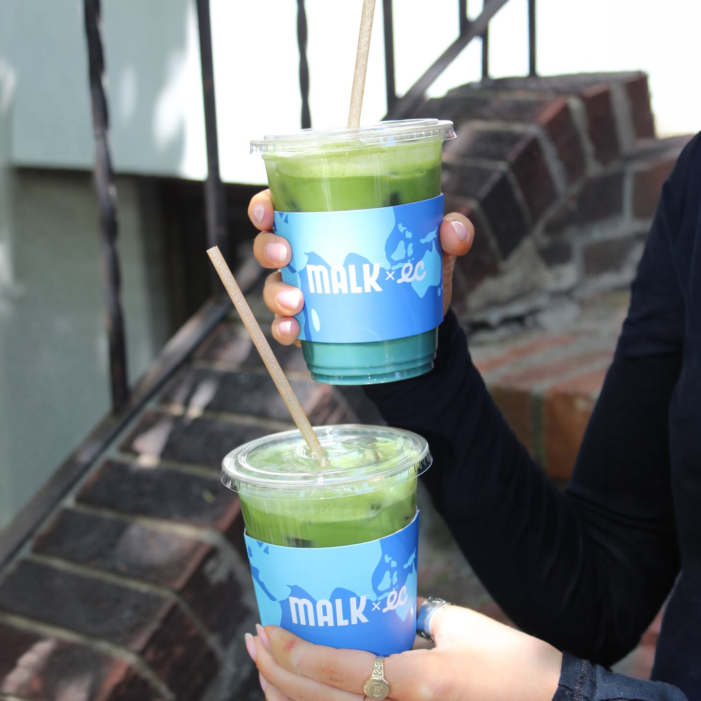 Two Earth Matcha drinks made with MALK Unsweetened Coconut Creamer, served in branded Earth Cups sleeves at Kijitora.