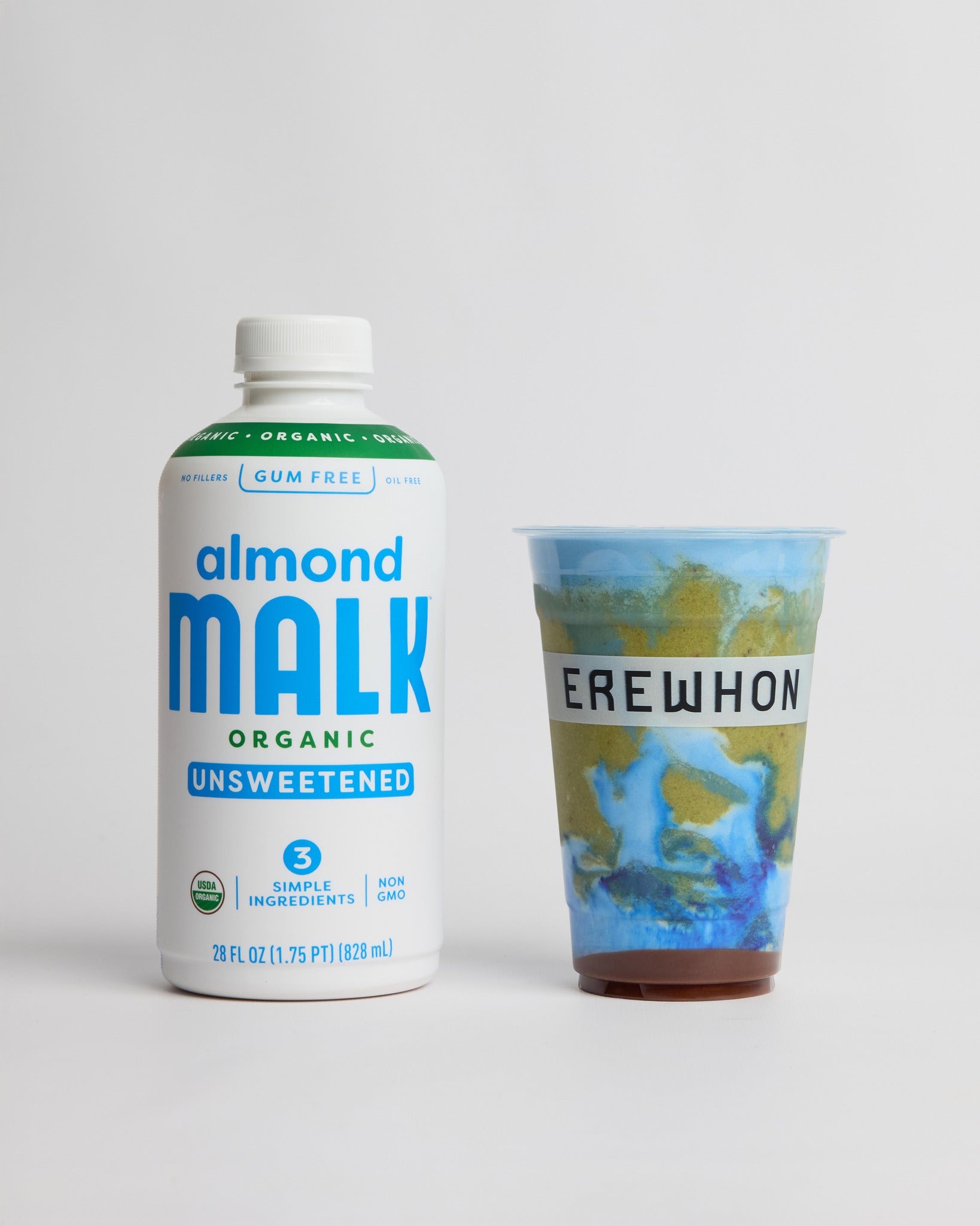 Bottle of Almond MALK next to a blue and green smoothie created by country superstar Kaycee Musgraves