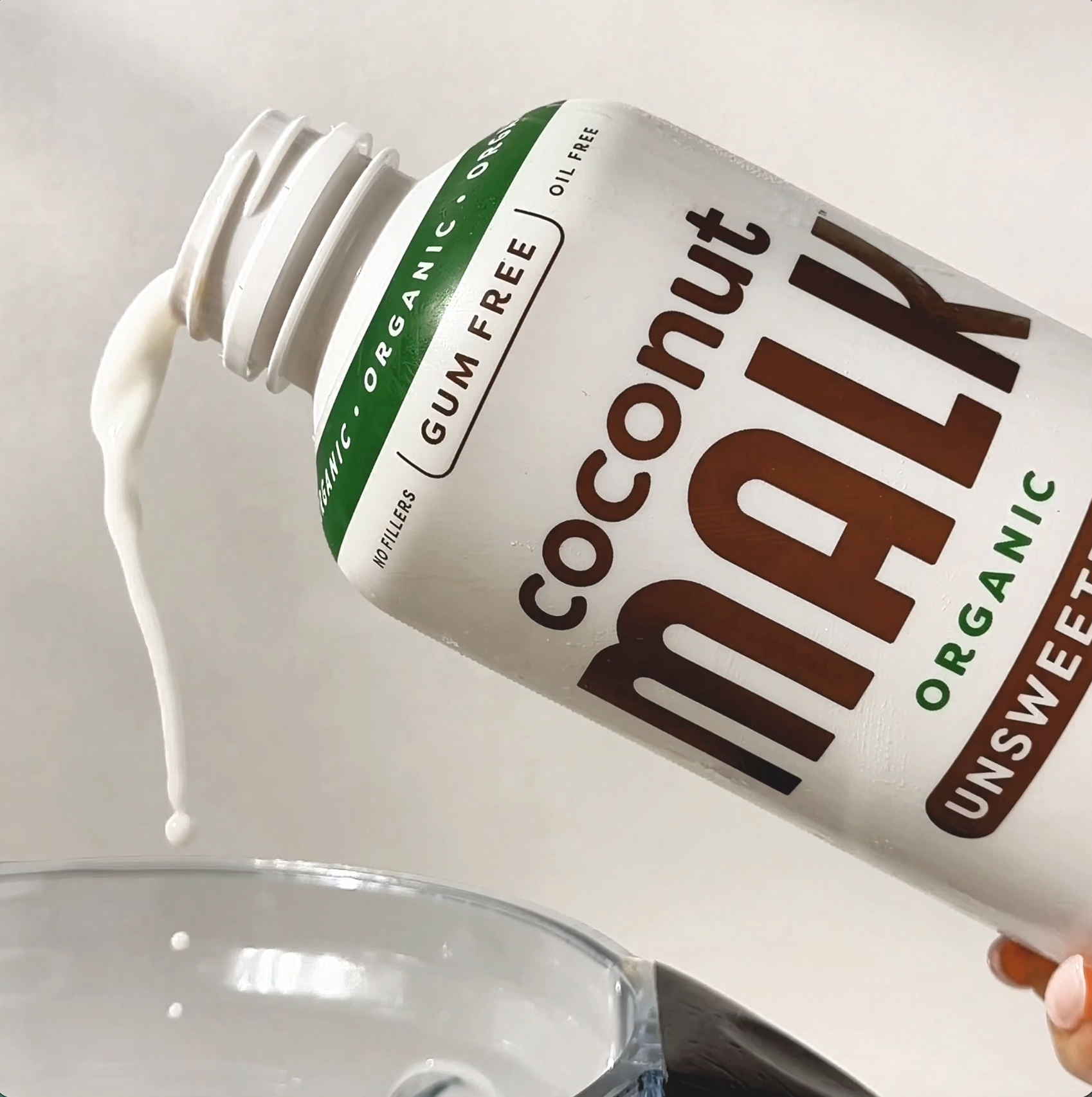 MALK Unsweetened Coconut Milk being poured into a smoothie