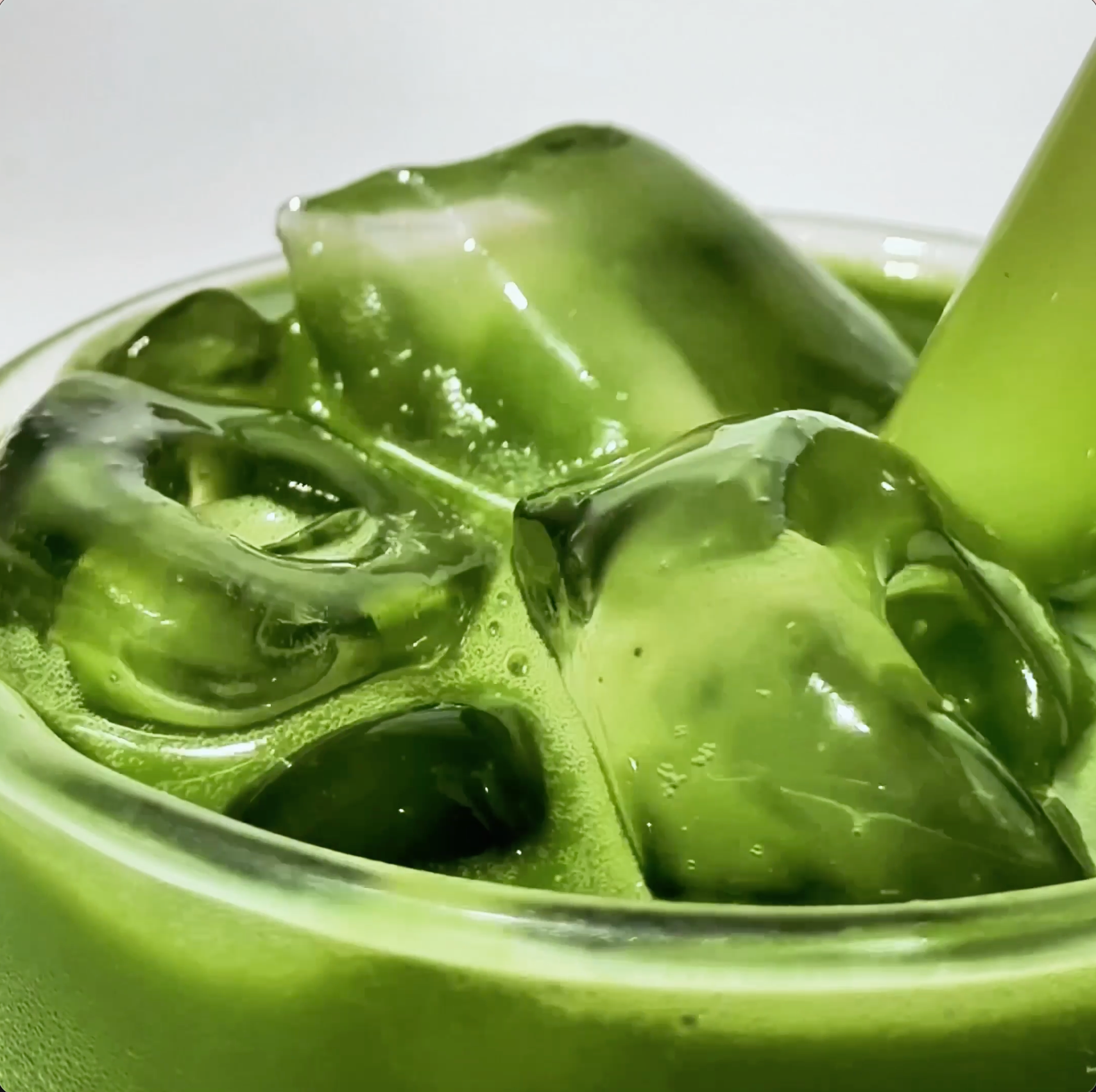 MALK Original Oat Milk being poured into a glass with matcha