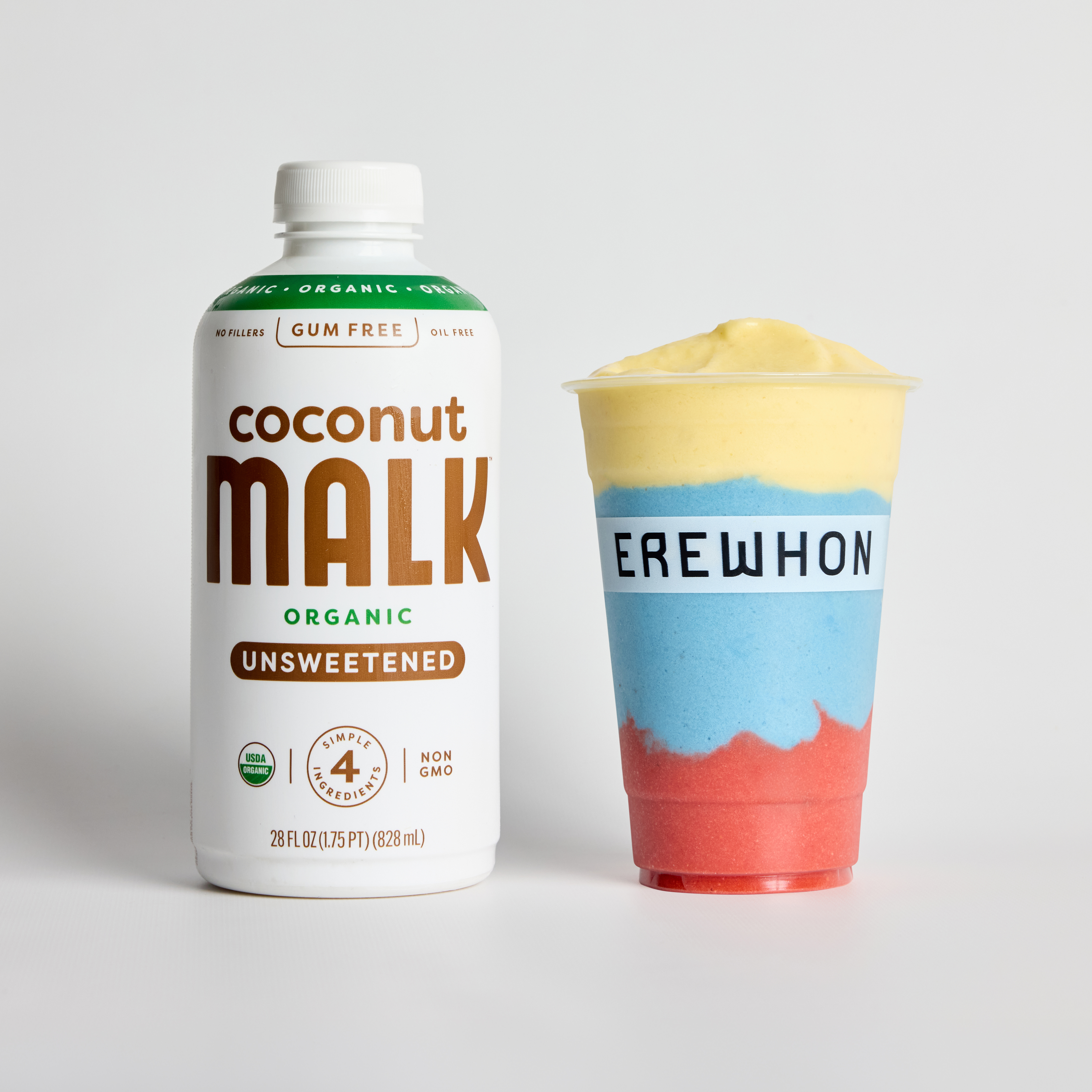 Bottle of MALK Organic Unsweetened Coconut Milk next to Erewhon’s colorful Chimba de Smoothie by J Balvin.