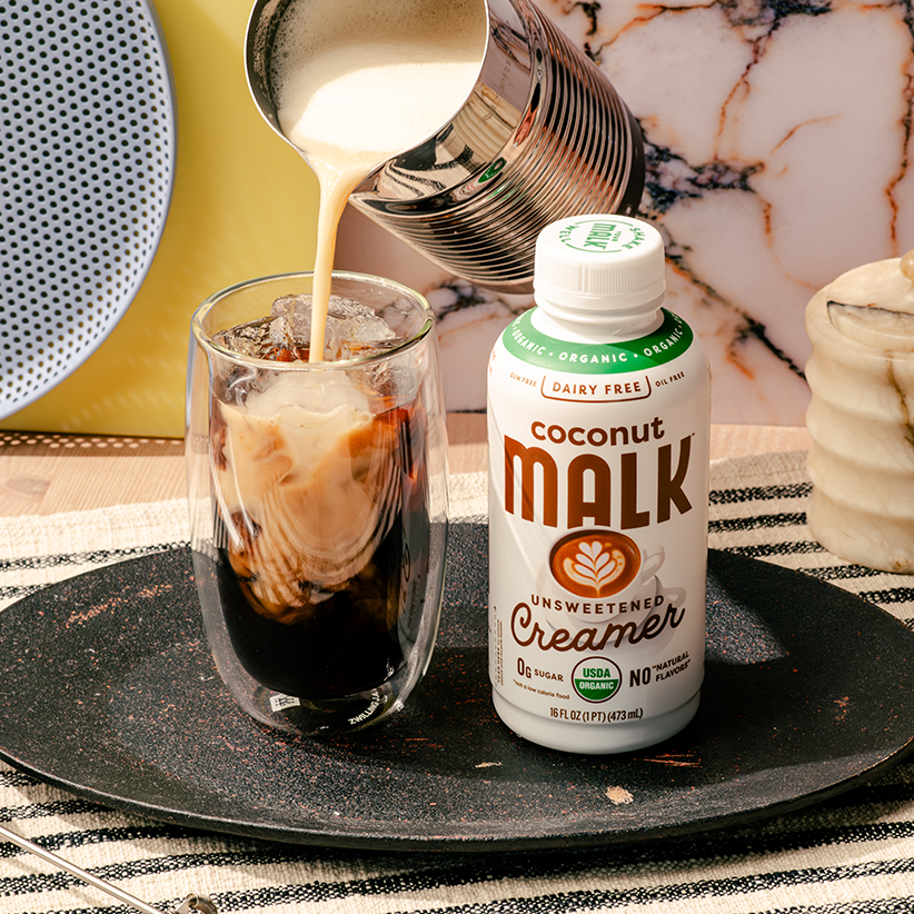 Salted caramel cream cold brew made with MALK Unsweetened Coconut Milk Coffee Creamer, poured over iced coffee.