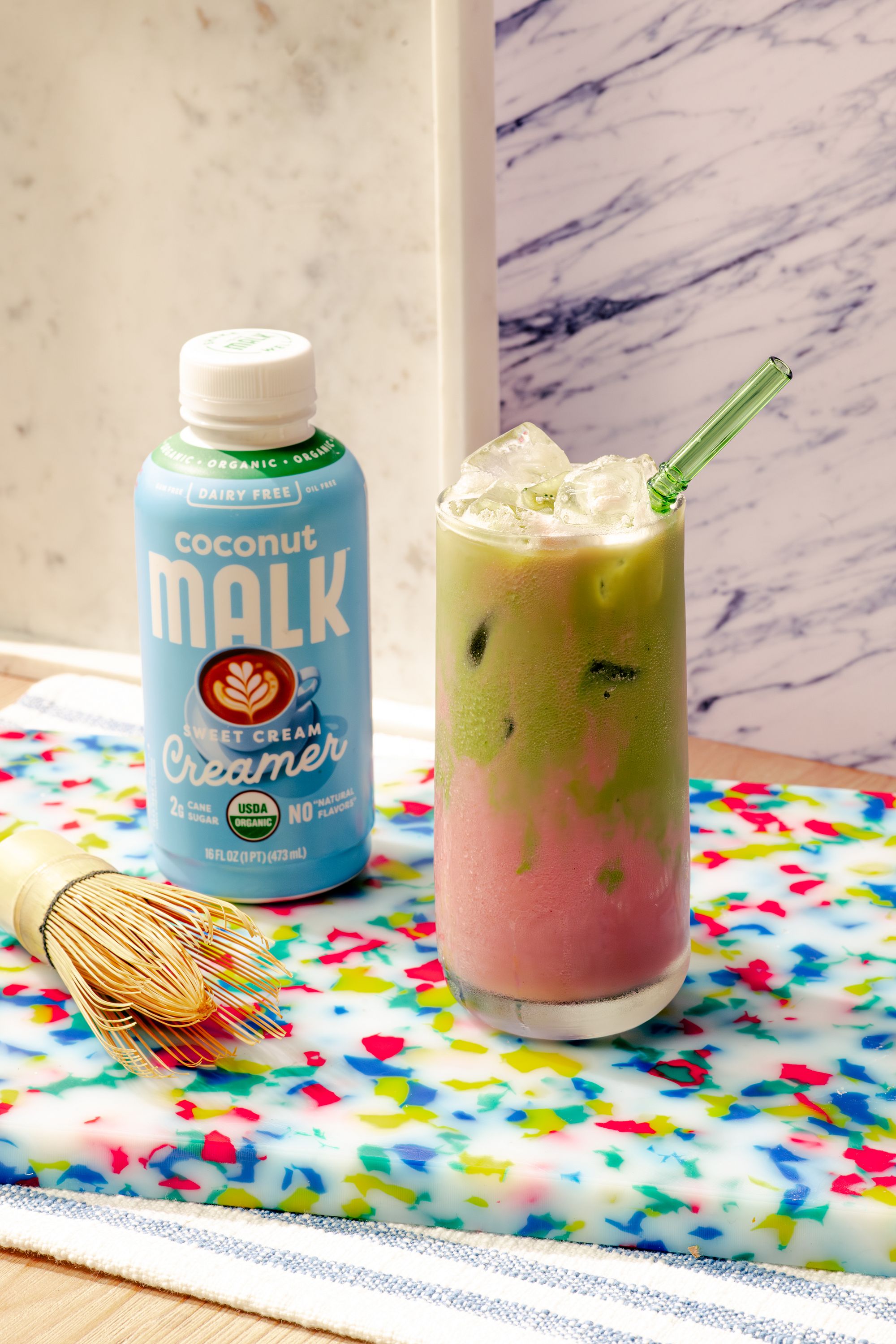 Strawberry sweet cream matcha made with MALK Sweet Cream Coconut Creamer over ice.