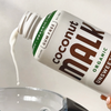 MALK Unsweetened Coconut Milk being poured into a smoothie 